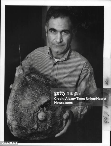 Roma Appianway Restaurant, Schenectady, New York - food, meats - Aldo Martoni holds prosciutto ham cured in traditional way. October 15, 1987