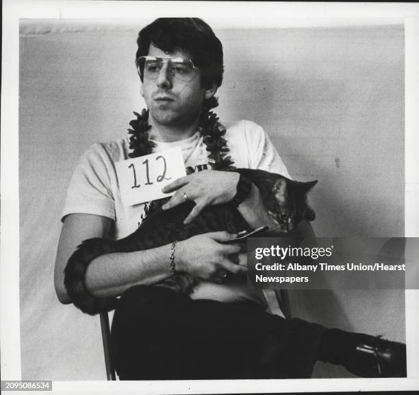 Albany, New York - Cats, Misc - Jonathan Gargill of Framingham, Massachusetts, holds his 6-month-old domestic shorthair Tiffany Sterling Pussywillow...