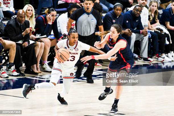 Honesty Scott-Grayson of the Auburn University Tigers tries to get past Helena Pueyo of the University of Arizona Wildcats during the First Four...
