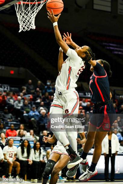 Honesty Scott-Grayson of the Auburn University Tigers shoots a layup ahead of Courtney Blakely of the University of Arizona Wildcats during the First...