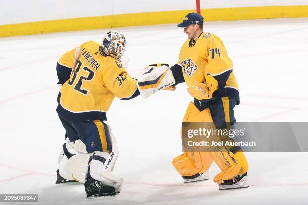 Goaltenders Kevin Lankinen and Juuse Saros of the Nashville Predators celebrate a 3-0 win against the Florida Panthers at the Amerant Bank Arena on...