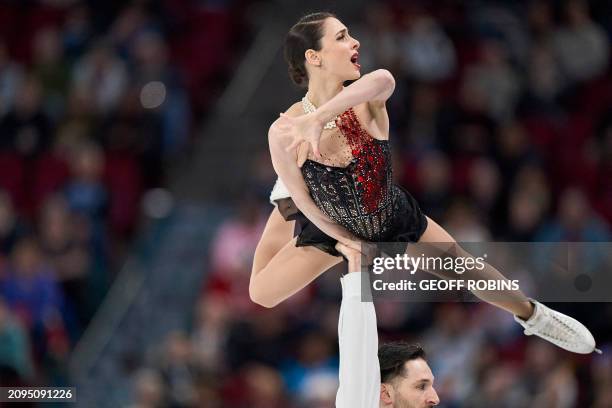 Canada's Deanna Stellato-Dudek and Maxime Deschamps skate their free program in the pairs competition at the International Skating Union World Figure...