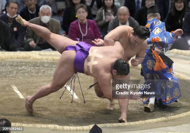 No. 17 maegashira Takerufuji is beaten by ozeki Hoshoryu on the 12th day of the 15-day Spring Grand Sumo Tournament in Osaka on March 21, 2024. The...
