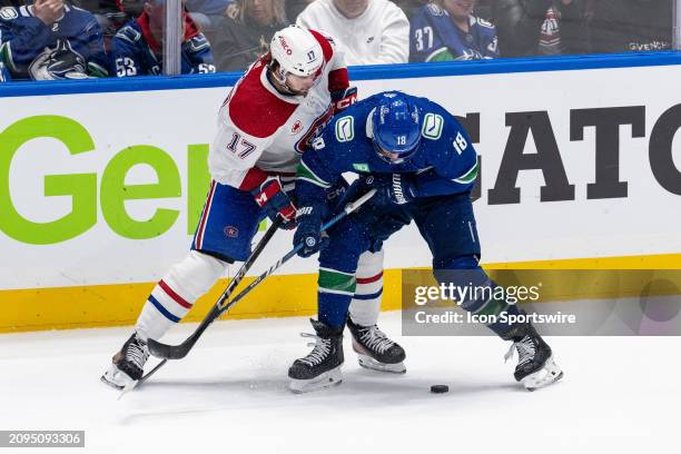 Montreal Canadiens right wing Josh Anderson and Vancouver Canucks center Sam Lafferty vie for the puck during an NHL game between the Montreal...