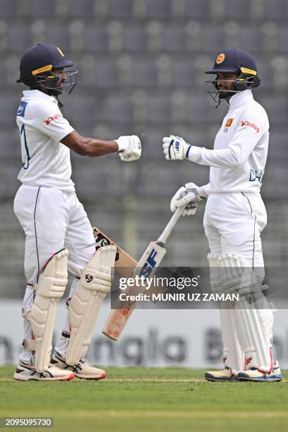 Sri Lanka's Kamindu Mendis celebrates with captain Dhananjaya de Silva after scoring a half-century during the first day of the first Test cricket...