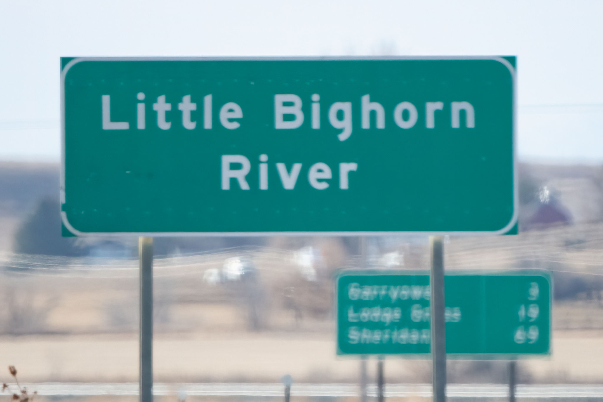 Highway sign marking the Little Bighorn River at the Little Bighorn Battlefield National Monument in southeastern Montana, in western USA of North America Highway sign marking the Little Bighorn River at the Little Bighorn Battlefield National Monument in southeastern Montana, in western USA of North America