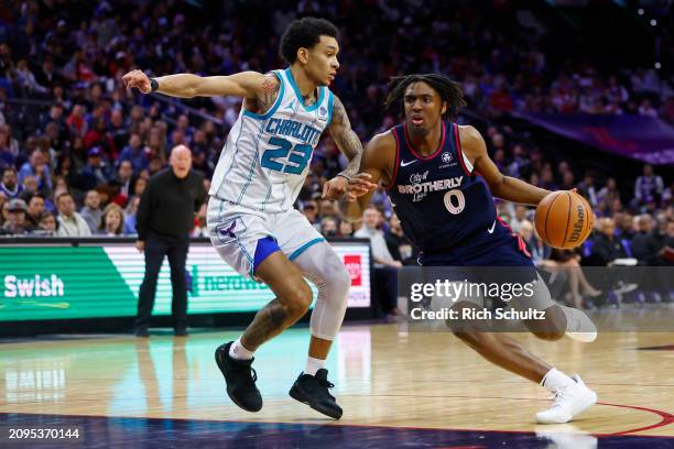 Tyrese Maxey of the Philadelphia 76ers in action against Tre Mann of the Charlotte Hornets during a game at the Wells Fargo Center on March 16, 2024...