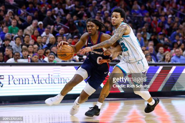 Tyrese Maxey of the Philadelphia 76ers in action against Tre Mann of the Charlotte Hornets during a game at the Wells Fargo Center on March 16, 2024...