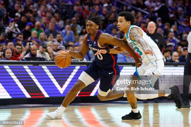 Tyrese Maxey of the Philadelphia 76ers in action against Tre Mann of the Charlotte Hornets during a game at the Wells Fargo Center on March 16, 2024...