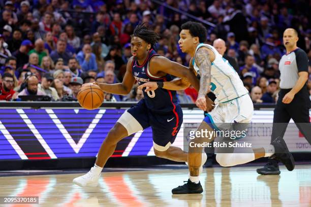 Tyrese Maxey of the Philadelphia 76ers in action against Tre Mann of the Charlotte Hornets during a game at the Wells Fargo Center on March 16, 2024...