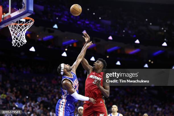 Thomas Bryant of the Miami Heat shoots over Buddy Hield of the Philadelphia 76ers during the fourth quarter at the Wells Fargo Center on March 18,...