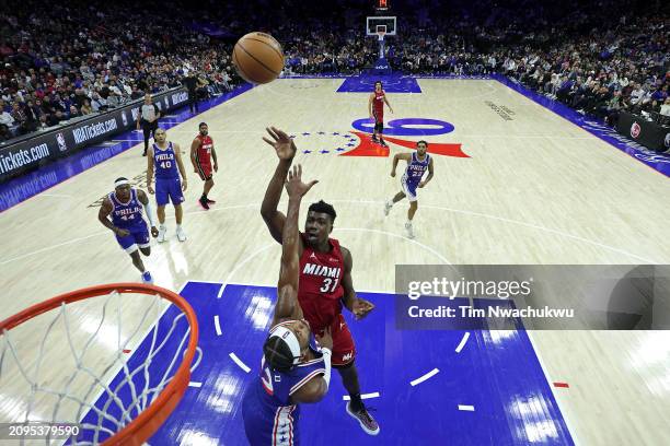 Thomas Bryant of the Miami Heat shoots over Buddy Hield of the Philadelphia 76ers during the fourth quarter at the Wells Fargo Center on March 18,...