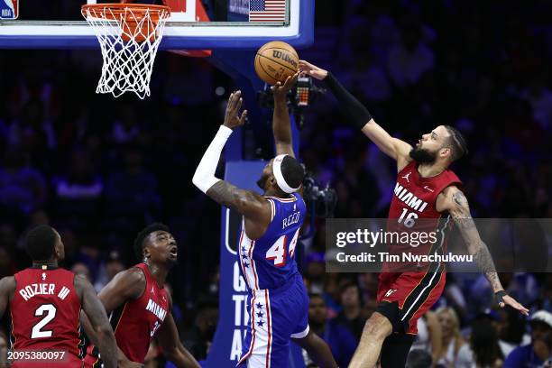 Caleb Martin of the Miami Heat blocks Paul Reed of the Philadelphia 76ers during the fourth quarter at the Wells Fargo Center on March 18, 2024 in...