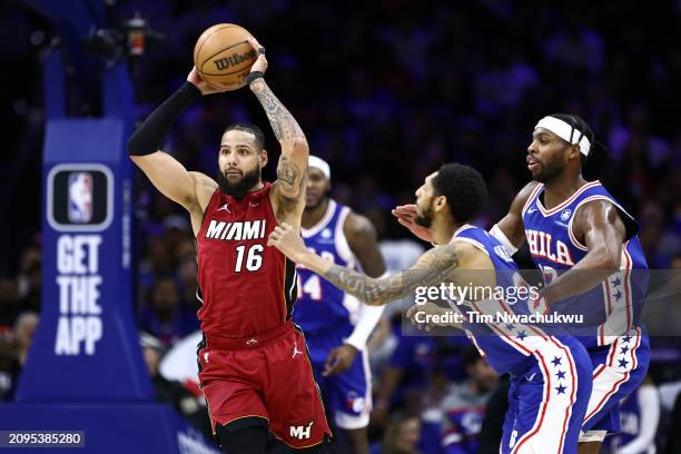 Caleb Martin of the Miami Heat looks attempts a pass past Cameron Payne of the Philadelphia 76ers during the third quarter at the Wells Fargo Center...