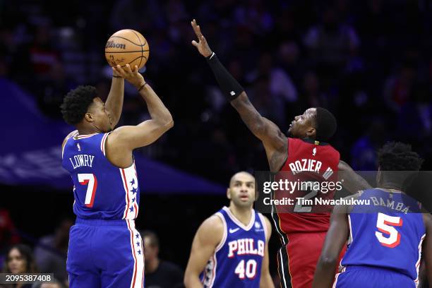 Kyle Lowry of the Philadelphia 76ers shoots past Terry Rozier of the Miami Heat during the third quarter at the Wells Fargo Center on March 18, 2024...