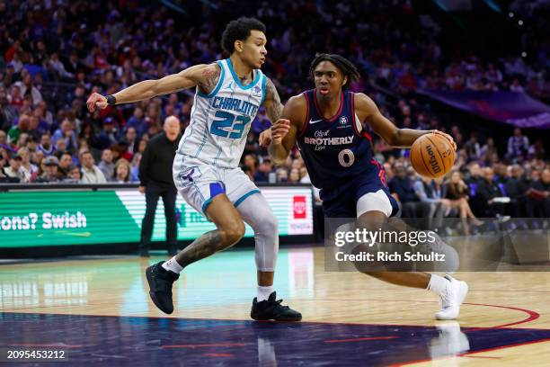 Tyrese Maxey of the Philadelphia 76ers in action against Tre Mann of the Charlotte Hornets during a game at the Wells Fargo Center on March 16, 2024...