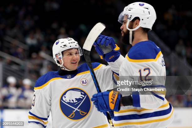 Jeff Skinner of the Buffalo Sabres celebrates his hat trick with Jordan Greenway against the Seattle Kraken during the third period at Climate Pledge...