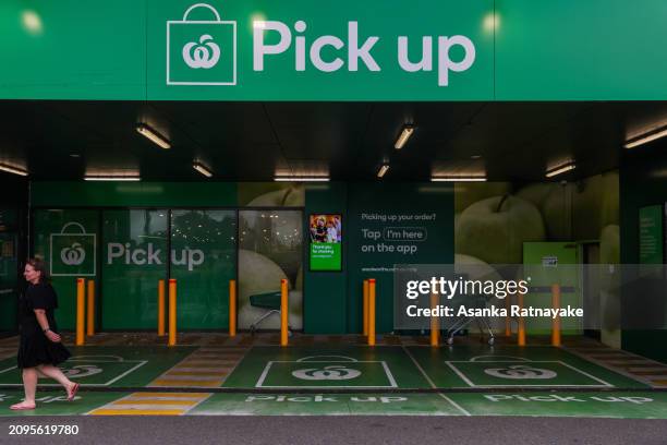 Customer walks past a Woolworths click and collect station at a Woolworths supermarket on March 19, 2024 in Melbourne, Australia. Australia's two...