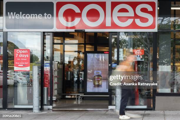 Customer walks past a Coles supermarket on March 19, 2024 in Melbourne, Australia. Australia's two major supermarket chains, Coles and Woolworths,...