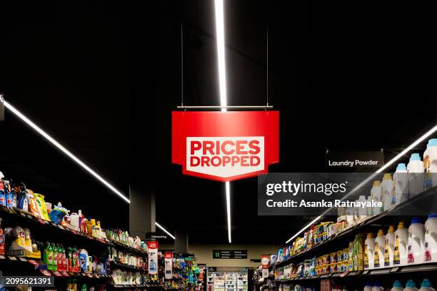 Prices dropped sign at a Woolworths supermarket on March 19, 2024 in Melbourne, Australia. Australia's two major supermarket chains, Coles and...