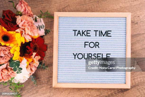 mixed flower bouquet and letter board with text take time for yourself - health motivational quotes stock pictures, royalty-free photos & images