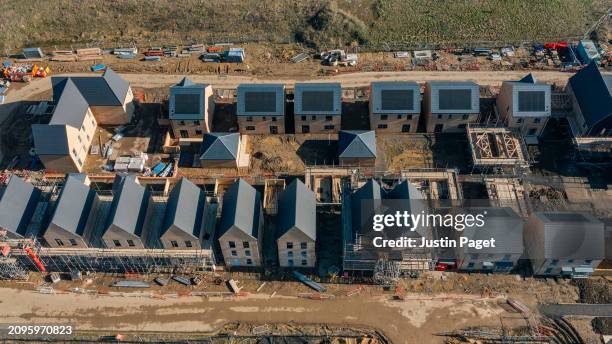 drone view of a residential building site under construction - green roof stock pictures, royalty-free photos & images