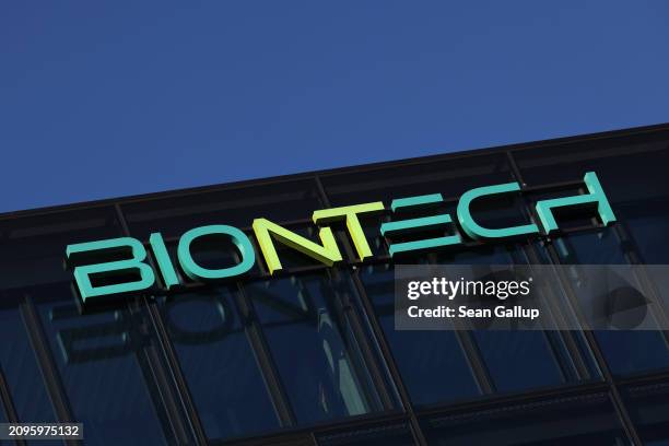 The logo of German biopharmaceutical company BioNTech hangs on an office building on March 19, 2024 in Berlin, Germany. BioNTech partnered with...