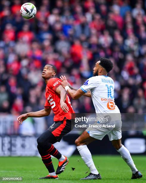 Warmed Omari of Stade Rennais competes for the ball with Pierre Emerick Aubameyang of Olympique de Marseille during the Ligue 1 Uber Eats match...