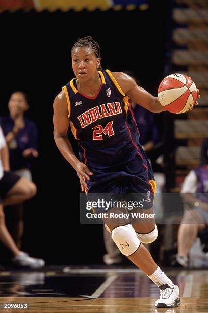 Tamika Catchings of the Indiana Fever drives up court against the Sacramento Monarchs during the WNBA game at ARCO arena on June 14, 2003 in...