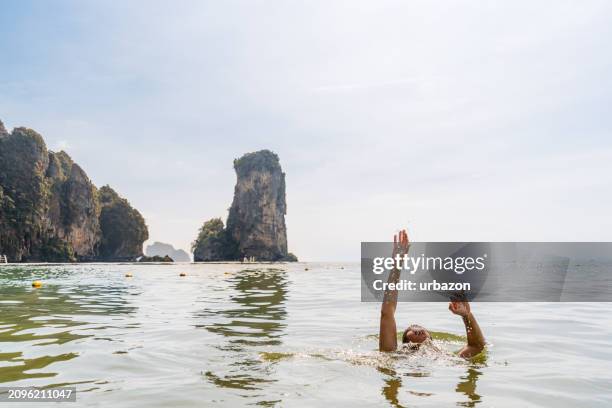young man drowning in the andaman sea in thailand - drowning stock pictures, royalty-free photos & images