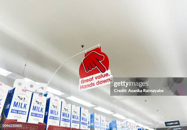 Coles supermarket 'big red hand down' advertising campaign signage is displayed inside a Coles supermarket on March 19, 2024 in Melbourne, Australia....