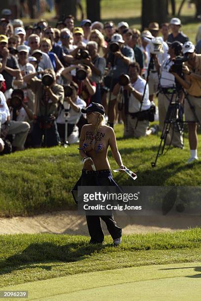Streaker rushes the 11th green as Jim Furyk putts during the final round of the 2003 US Open on the North Course at the Olympia Fields Country Club...