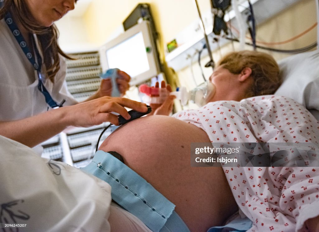 Close up of abdomen of pregnant woman in hospital.
