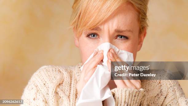 woman with tissue - blowing nose stock pictures, royalty-free photos & images