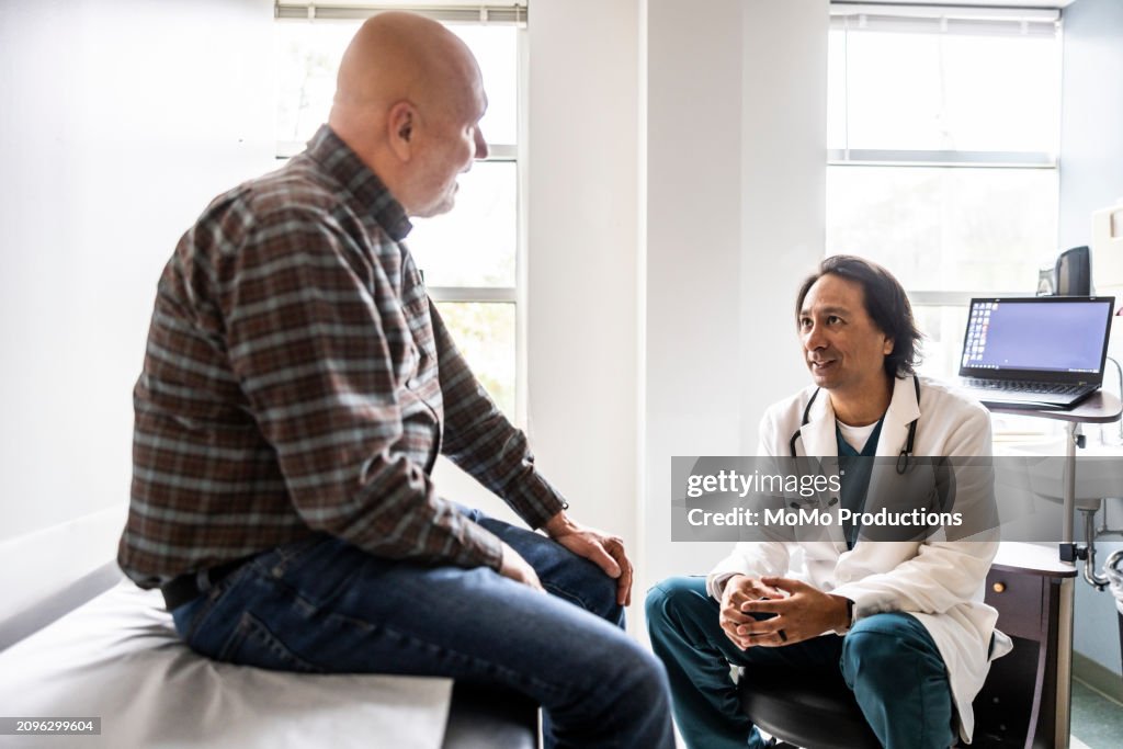 Doctor and senior man discussing treatment in exam room