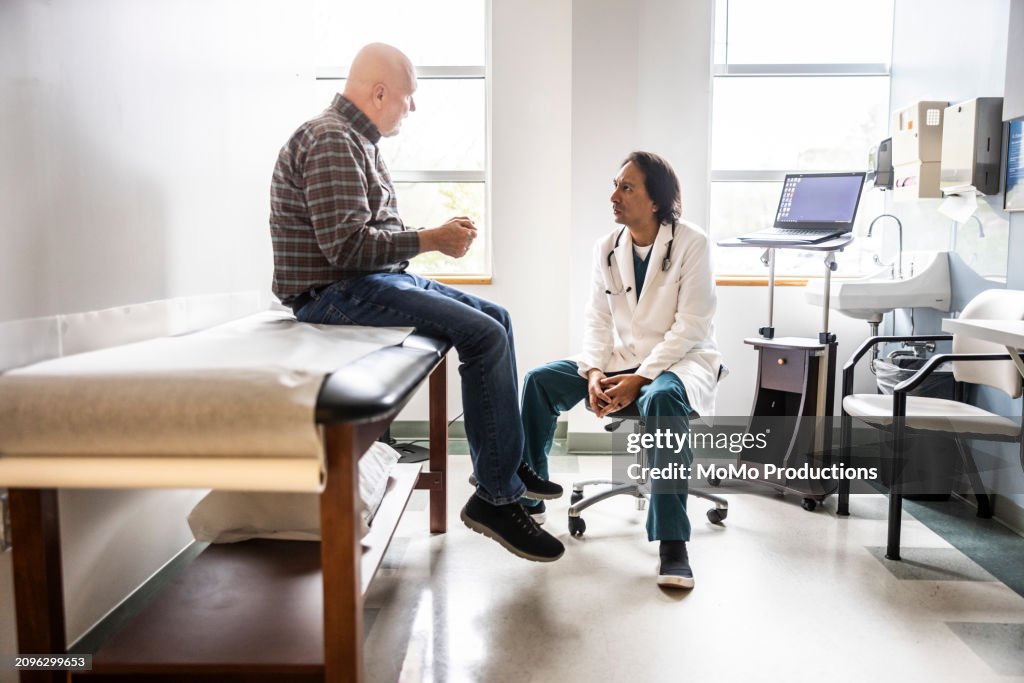 Doctor and senior man discussing treatment in exam room