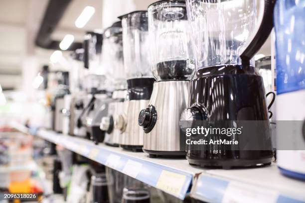 electric mixers and blenders on a shelf in a store or showroom - loja de utensílios de cozinha imagens e fotografias de stock