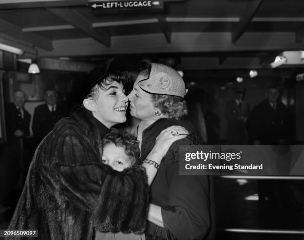 Actress Joan Collins returns to Britain from the US to embrace her mother Elsa and younger brother Bill, London Airport, October 6th 1955.