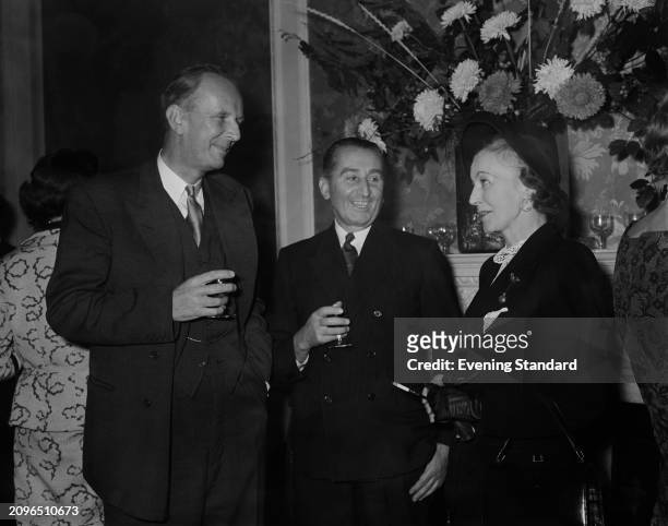 Conservative politician and businessman, Wing Commander Sir Norman Hulbert left, with RAF Air Chief Marshal Sir Francis Fogarty and the wife of Air...