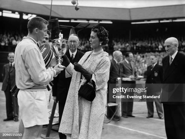 Tennis player Tony Trabert receives the Men's Singles trophy from president of the Wimbledon All England Lawn Tennis and Croquet Club, Princess...