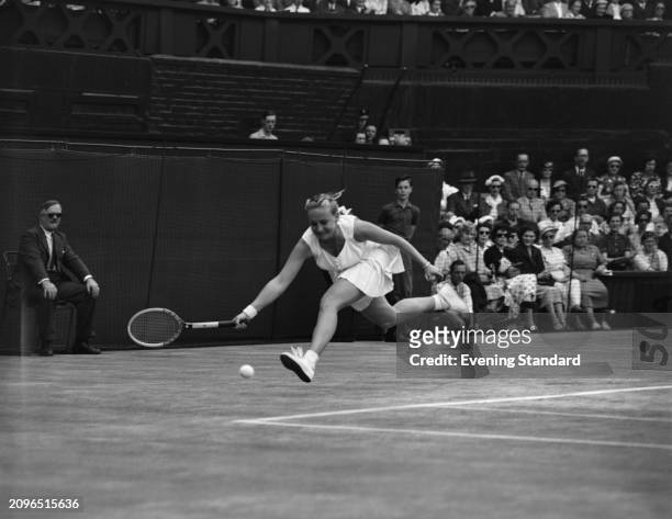 Tennis player Darlene Hard plays a shot during the Women's Singles semi-final at the Wimbledon Championships, London, June 30th 1955. Hard lost to...