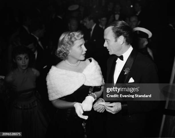 Socialite Sharman Douglas with actor John Mills at a film premiere in London, August 13th 1955.