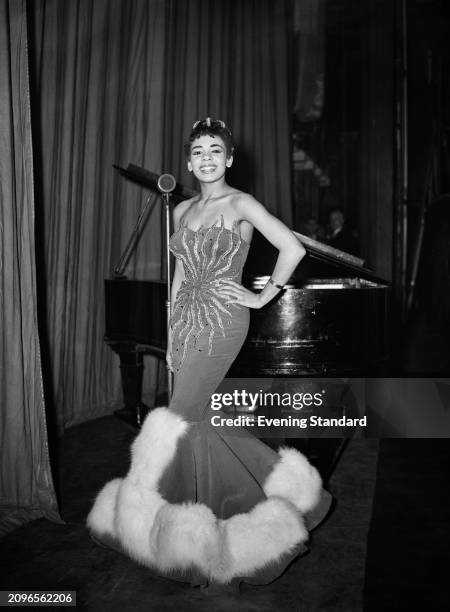 Welsh singer Shirley Bassey dressed in an evening gown on stage, February 1st 1956.
