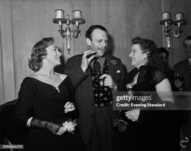 Actor and comedian Terry Thomas with Patricia Haywood, left, and Elizabeth Bruce at a social event, February 2nd 1956.