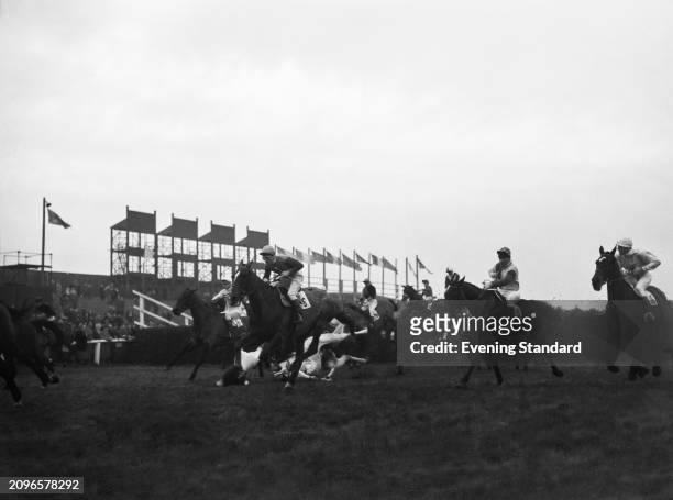 Racehorse 'High Guard' ridden by Arthur Thompson , left, after jumping a fence at the Grand National horse race, Aintree, Liverpool, March 24th 1956....