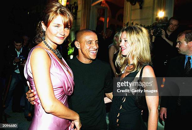Model Helena Christien, footballer Roberto Carlos and model Kate Moss attend a fashion show organised by Fawaz Grossi showcasing Galliano designs and...