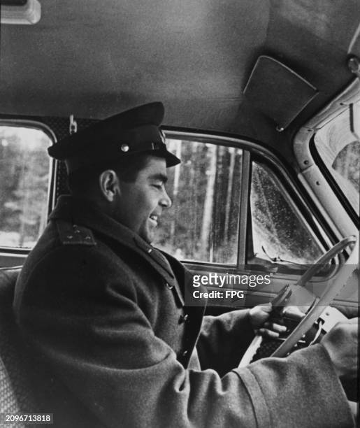 Soviet cosmonaut Andrian Nikolayev driving a car, Russia, 1962.