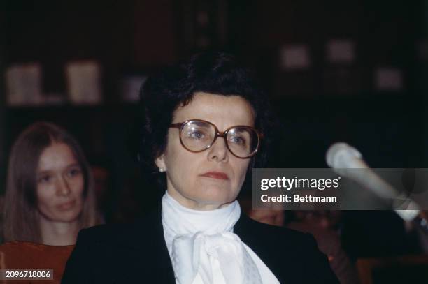 Dianne Feinstein , the Mayor of San Francisco, wearing glasses and a large white bow around her neck during an appearance before the Senate Finance...