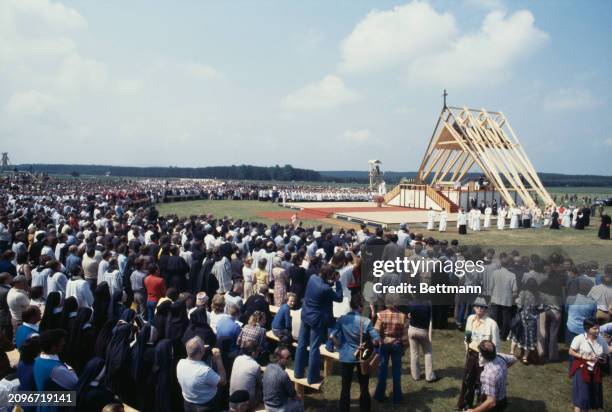 Pope John Paul II celebrating an open-air mass under a wooden structure in Nowy Targ during a visit to Poland, June 8th 1979.