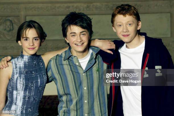 Actors Emma Watson, Daniel Radcliffe and Rupert Grint attend a photocall for the movie "Harry Potter and the Chamber of Secrets" at the Guildhall...